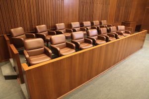 Invisible jury prepares to hear case against unknown person for unspecified damages.