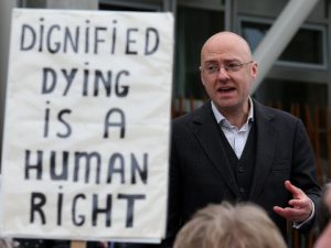 euthanasia-supporter-speaks-with-other-supporters-outside-scottish-parliament